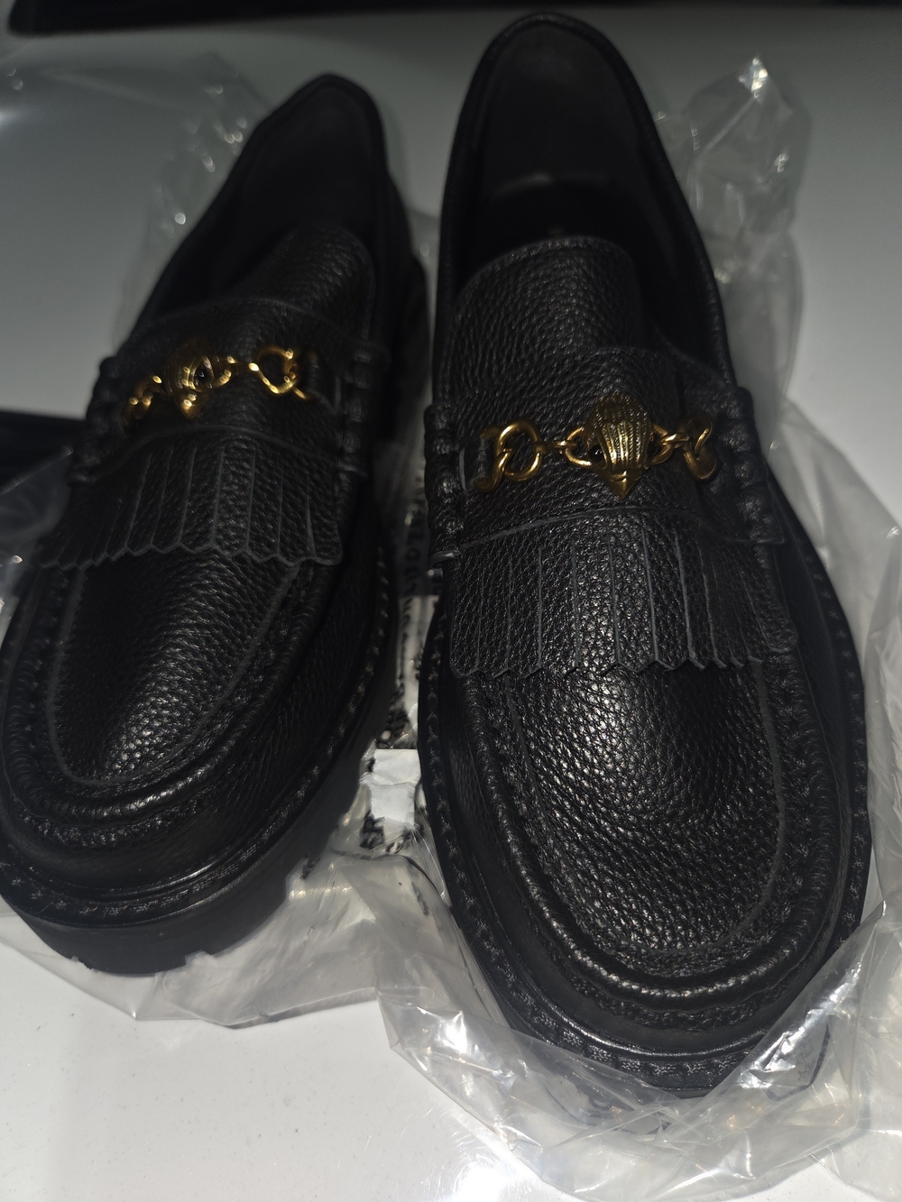 Kurt Geiger Black Pebbled Leather Kiltie Loafers with Gold Chain